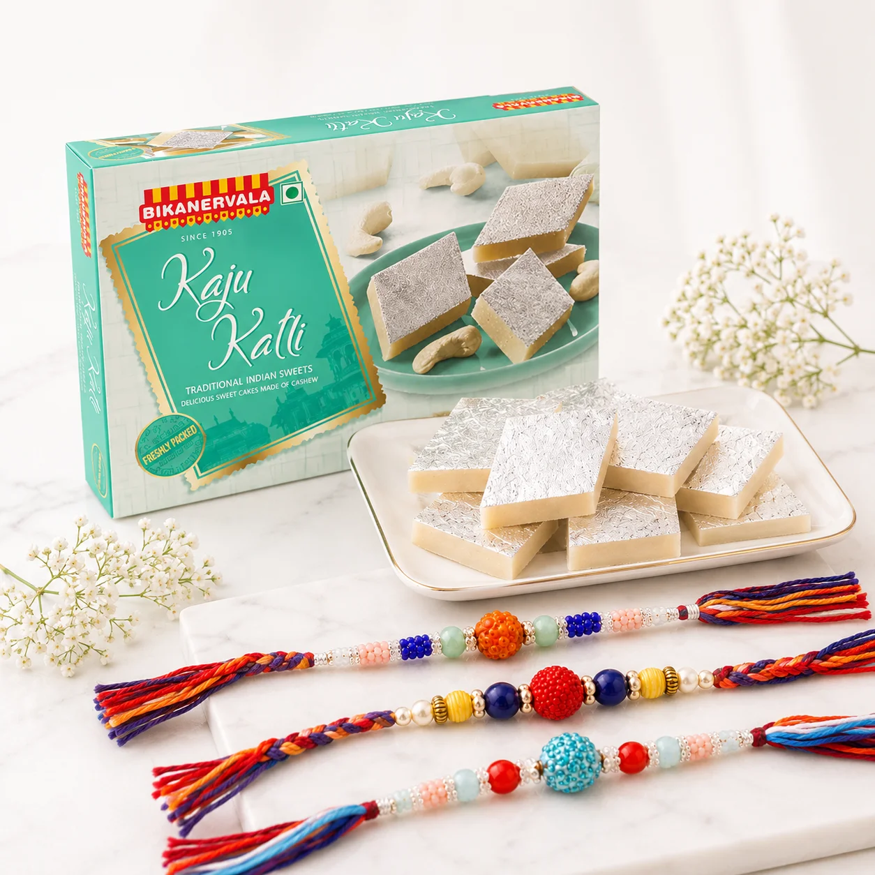 Rangoli Rakhi Kaju Katli Celebration Box Gift with 250g kaju katli and three colourful designer rakhis for Raksha Bandhan
